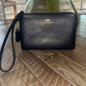 Like new, Coach coated  canvas navy  wristlet.